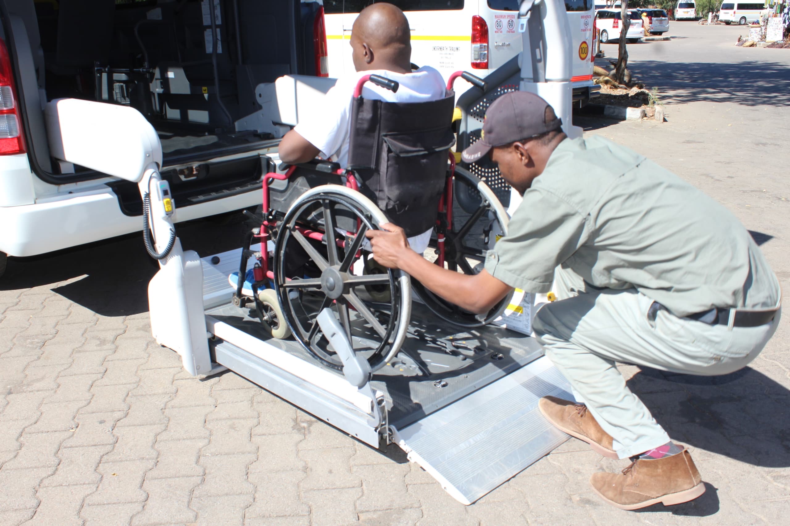 Accessible safari vehicle positioned beside a traveller's wheelchair