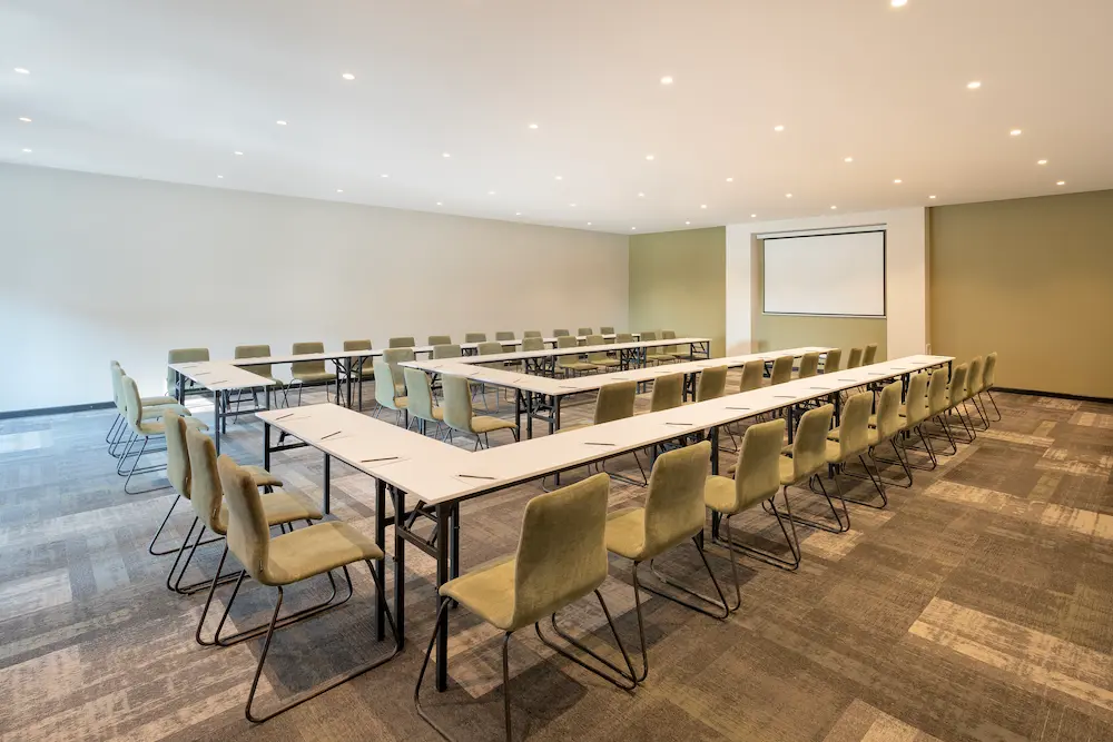 Meeting room arranged in a U-shape for a corporate meeting