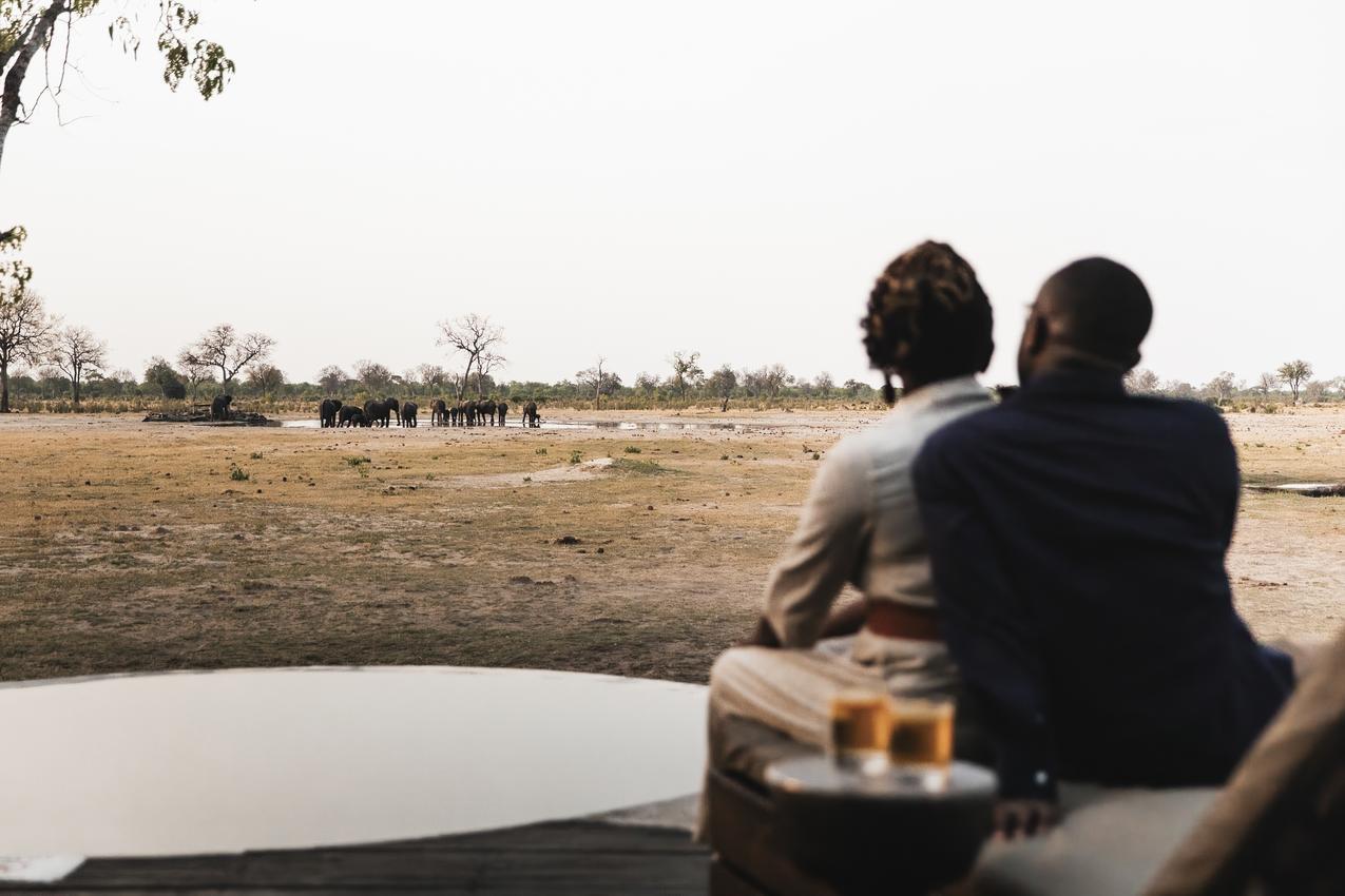 Guests watching the waterhole at Little Makalolo in Hwange