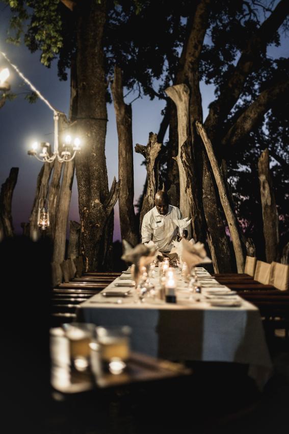 Candlelit outdoor dinner on a Hwange honeymoon