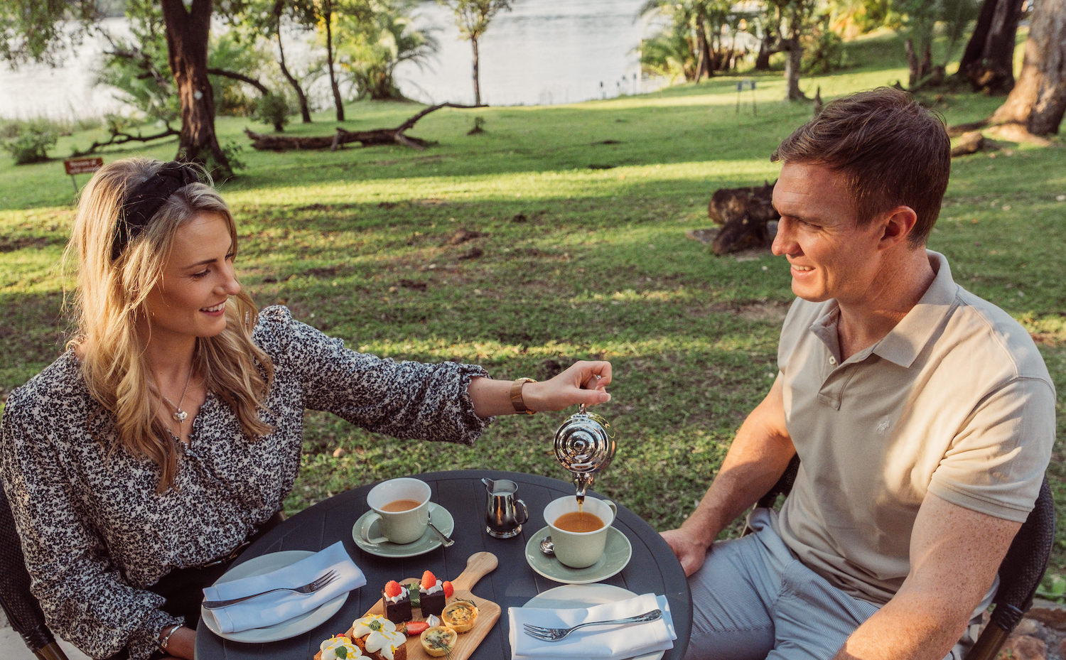Couple relaxing beside the Zambezi River
